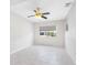 Bright bedroom with white walls, a window and tile flooring and a ceiling fan at 366 12Th Ave, Indian Rocks Beach, FL 33785