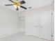 Bedroom with white walls, closet, ceiling fan, and white marble-patterned tile flooring at 366 12Th Ave, Indian Rocks Beach, FL 33785