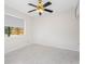 Bedroom featuring white walls, ceiling fan, marble tile floors, and a window for natural light at 366 12Th Ave, Indian Rocks Beach, FL 33785