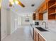 A modern kitchen with stainless steel appliances, wooden cabinetry, white countertops, and a tiled backsplash at 366 12Th Ave, Indian Rocks Beach, FL 33785