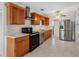 Modern kitchen with stainless steel appliances, wooden cabinetry, white countertops, and a tiled backsplash at 366 12Th Ave, Indian Rocks Beach, FL 33785