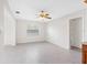 Bright living room featuring white walls and tile flooring, ceiling fan and window with blinds at 366 12Th Ave, Indian Rocks Beach, FL 33785
