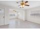 Open-concept living room with white walls, tile flooring, and natural light from multiple windows at 366 12Th Ave, Indian Rocks Beach, FL 33785