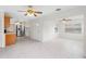 Open living space featuring white walls, tile floors, stainless steel appliances and ceiling fans at 366 12Th Ave, Indian Rocks Beach, FL 33785