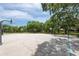 Community basketball court with multiple hoops surrounded by lush greenery at 3716 Janus Way, Palm Harbor, FL 34685