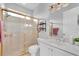 Well-maintained bathroom with a golden framed shower, tile floor and white vanity at 3716 Janus Way, Palm Harbor, FL 34685