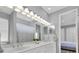 Bright bathroom featuring a long vanity with double sinks and a large, well-lit mirror at 3716 Janus Way, Palm Harbor, FL 34685