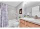 Traditional bathroom with a shower-tub combo, framed art and a single vanity at 3716 Janus Way, Palm Harbor, FL 34685
