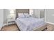 Bright bedroom with upholstered headboard, wood floors, and ensuite bath at 3716 Janus Way, Palm Harbor, FL 34685