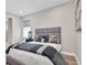 Comfortable bedroom features a gray upholstered headboard and coordinated decor at 3716 Janus Way, Palm Harbor, FL 34685