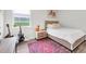 Well lit bedroom with wood floors, guitar and large window at 3716 Janus Way, Palm Harbor, FL 34685
