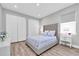 Comfortable bedroom with a plush, upholstered bed, gray walls, and two closets at 3716 Janus Way, Palm Harbor, FL 34685