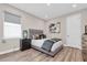 Modern bedroom featuring neutral walls, wood-look floors, and a stylish accent table at 3716 Janus Way, Palm Harbor, FL 34685