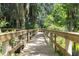 Scenic wooden boardwalk winding through a serene natural area, perfect for leisurely strolls at 3716 Janus Way, Palm Harbor, FL 34685