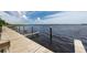 Community dock featuring wooden planks and slips offering lake access and boat mooring opportunities at 3716 Janus Way, Palm Harbor, FL 34685