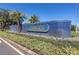 Elegant community sign with lush landscaping and blue tiled backdrop at 3716 Janus Way, Palm Harbor, FL 34685