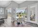 Breakfast nook with views of the screened-in pool area and outdoor living space at 3716 Janus Way, Palm Harbor, FL 34685