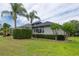 Exterior of a well maintained home with an oversized yard and mature landscaping at 3716 Janus Way, Palm Harbor, FL 34685