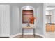 Inviting hallway featuring neutral paint and decor with a peek into the bathroom at 3716 Janus Way, Palm Harbor, FL 34685