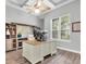 Bright home office with large desk, ample storage, and natural light at 3716 Janus Way, Palm Harbor, FL 34685