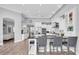 Modern kitchen with white cabinets, black countertops, stainless steel appliances, and seating at the island at 3716 Janus Way, Palm Harbor, FL 34685