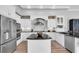 Modern kitchen with stainless steel appliances, granite countertops, and a central island at 3716 Janus Way, Palm Harbor, FL 34685