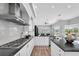 Open kitchen design with stainless steel appliances, granite countertops, and seamless connection to outdoor views at 3716 Janus Way, Palm Harbor, FL 34685