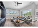 Comfortable living room featuring stylish decor, a sectional sofa, and views of the pool area at 3716 Janus Way, Palm Harbor, FL 34685
