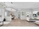 Bright and spacious living room with hardwood floors, modern lighting, and an open floor plan at 3716 Janus Way, Palm Harbor, FL 34685