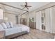 Bright main bedroom featuring wood-look floors, a TV, and patio access at 3716 Janus Way, Palm Harbor, FL 34685