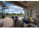 Cozy outdoor patio area features comfortable seating, a fire pit, a pool, and beautiful sky views at 3716 Janus Way, Palm Harbor, FL 34685