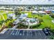 Aerial view of community pool, pond and surrounding neighborhood in a vibrant coastal community at 404 Bahama Grande Blvd, Apollo Beach, FL 33572