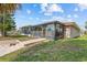 Backyard exterior with a screened in enclosure and grassy yard at 4274 Deleon Dr, Hernando Beach, FL 34607