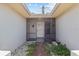 Inviting screened entryway featuring decorative tile and a front door with sidelights at 4274 Deleon Dr, Hernando Beach, FL 34607