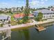 Waterfront home with a red roof, lush landscaping, private dock, and serene water views at 4274 Deleon Dr, Hernando Beach, FL 34607