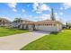Charming single-story home with a red tile roof and an attached two-car garage at 4274 Deleon Dr, Hernando Beach, FL 34607