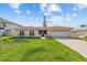Charming single-story home with a red tile roof, a well-maintained lawn, and an attached two-car garage at 4274 Deleon Dr, Hernando Beach, FL 34607