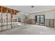 Renovation in progress in the spacious living room with cased openings and sliding glass doors at 4274 Deleon Dr, Hernando Beach, FL 34607