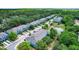 Aerial view of a long row of blue townhomes with lush landscaping and ponds at 4528 Amberly Oaks Ct, Tampa, FL 33614
