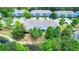 Aerial view of blue townhomes with lush landscaping and a community pond at 4528 Amberly Oaks Ct, Tampa, FL 33614