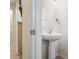 Small bathroom with pedestal sink, mirror, and tile flooring at 4528 Amberly Oaks Ct, Tampa, FL 33614