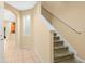 Inviting foyer with tile flooring, staircase, and archway leading to the kitchen at 4528 Amberly Oaks Ct, Tampa, FL 33614