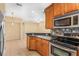 Kitchen featuring stainless steel appliances, wood cabinetry, and neutral color scheme at 4528 Amberly Oaks Ct, Tampa, FL 33614