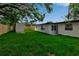 Side view of the house from the backyard, showcasing the lawn, shed, and exterior at 4624 83Rd Terrace N, Pinellas Park, FL 33781