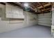 Unfinished basement featuring painted concrete walls, storage, and mechanical components at 4624 83Rd Terrace N, Pinellas Park, FL 33781