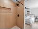 Stylish bathroom featuring a sleek shower with wood-look tile and modern fixtures, adjacent to a comfy bedroom at 4624 83Rd Terrace N, Pinellas Park, FL 33781