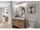 Modern bathroom with a wood vanity, circular mirror, and stylish lighting fixtures at 4624 83Rd Terrace N, Pinellas Park, FL 33781