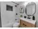 Well-lit bathroom with a combination of black and white tile, a modern vanity, and contemporary fixtures at 4624 83Rd Terrace N, Pinellas Park, FL 33781