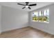 Bright, empty bedroom featuring sleek ceiling fan, hardwood floors and natural light from the window at 4624 83Rd Terrace N, Pinellas Park, FL 33781