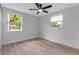 Sunny bedroom featuring two windows and a ceiling fan for a comfortable, airy space at 4624 83Rd Terrace N, Pinellas Park, FL 33781